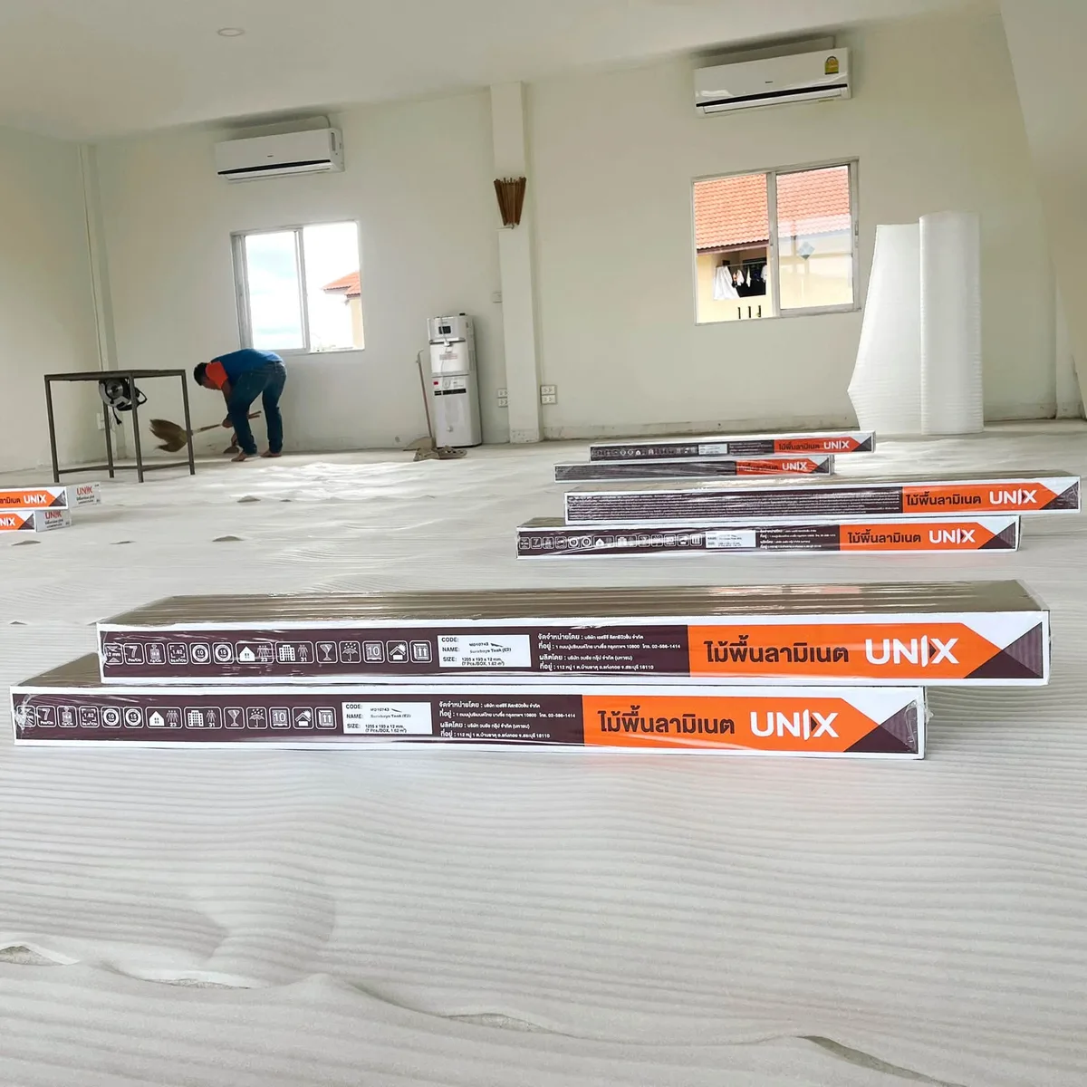Boxes of new laminate flooring delivered to the studio