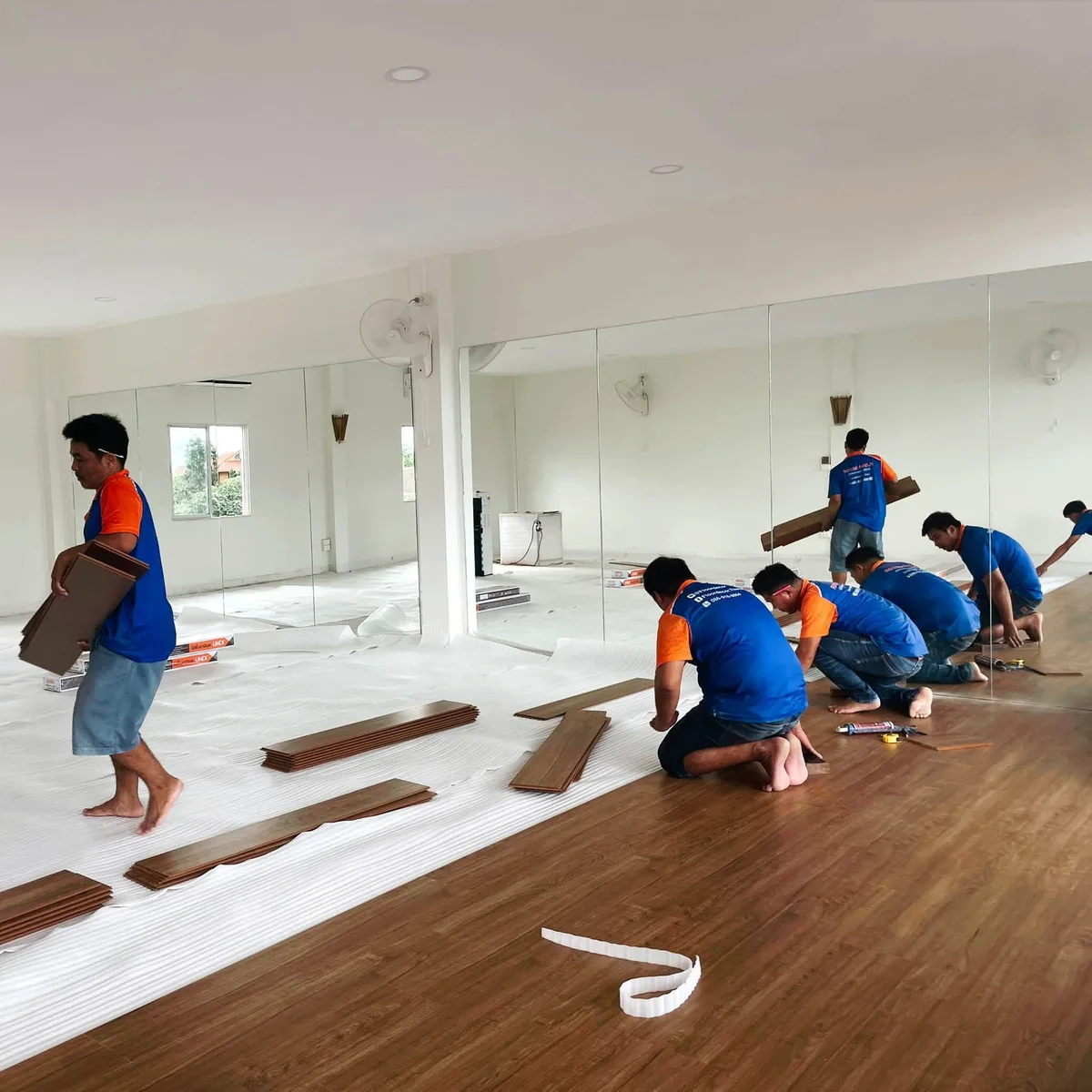 Installation team working on the studio floor