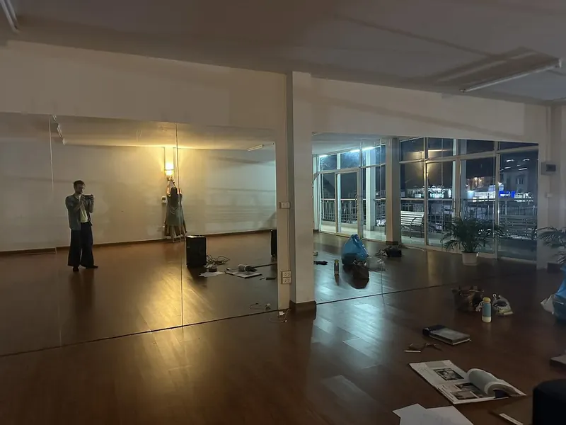 The studio in the evening with a warm wall lamp and city lights outside