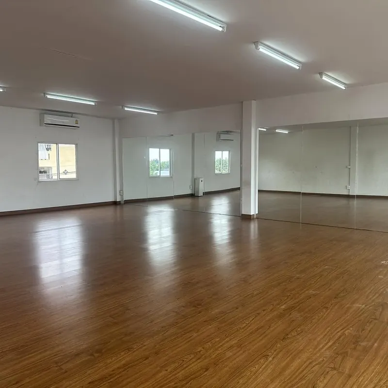 The studio's mirrored wall and wooden floor